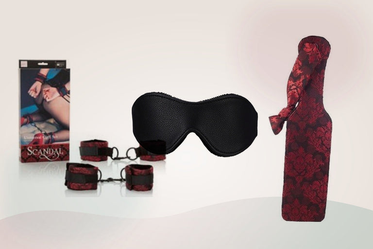 Cuffs, a blindfold and a paddle selected from the Adult Direct bondage range